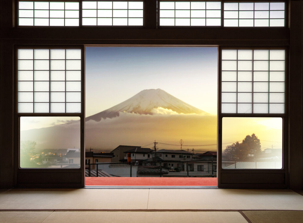 Traditional Japanese indoor  house and paper sliding doors and tatami mat open to View of a beautiful Fuji mountain in sunset and japanese house in autumn season. Kawaguchiko, Yamanashi, Japan